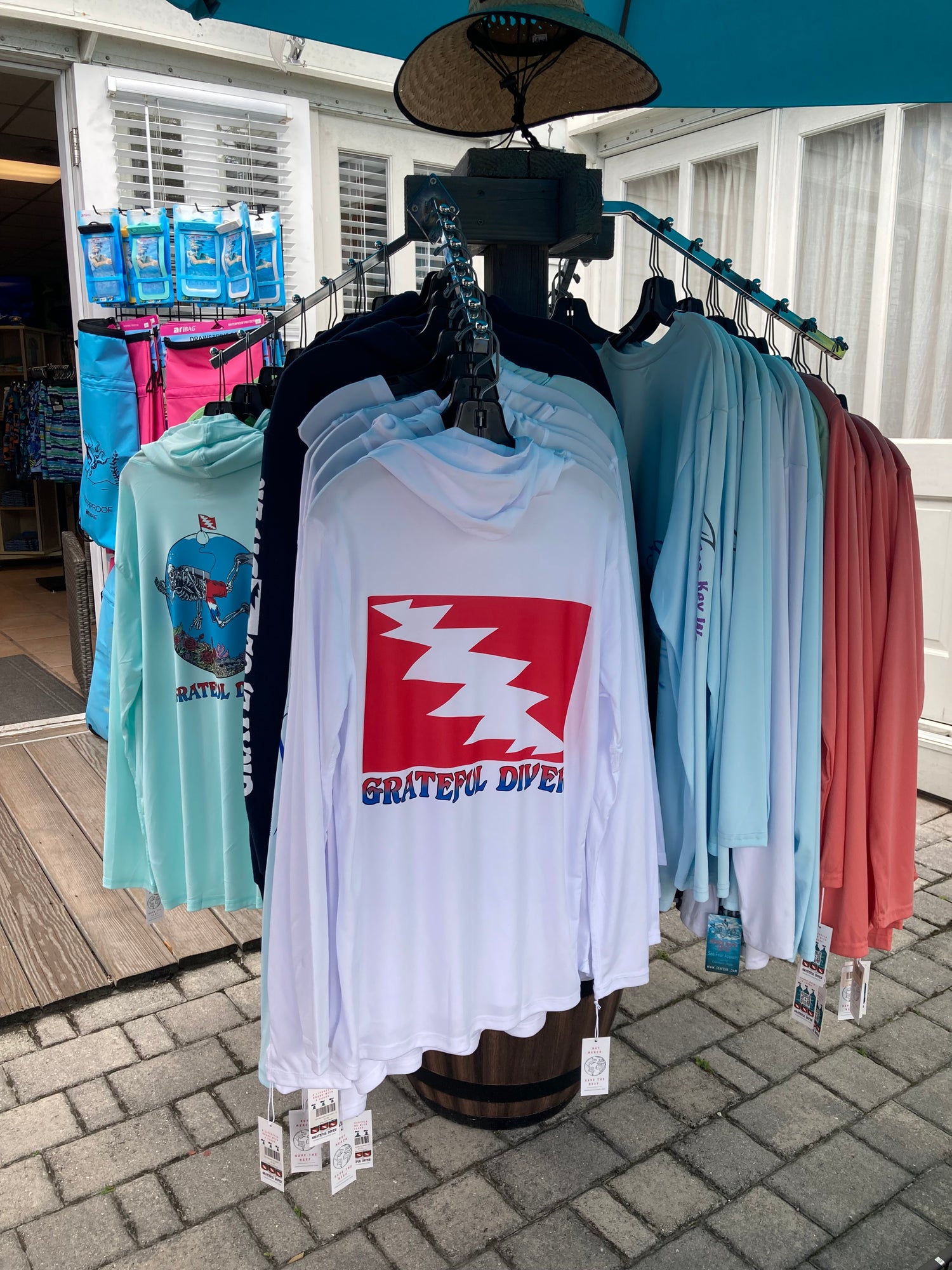 rack of Grateful Diver UV Shirts in front of a clothing store