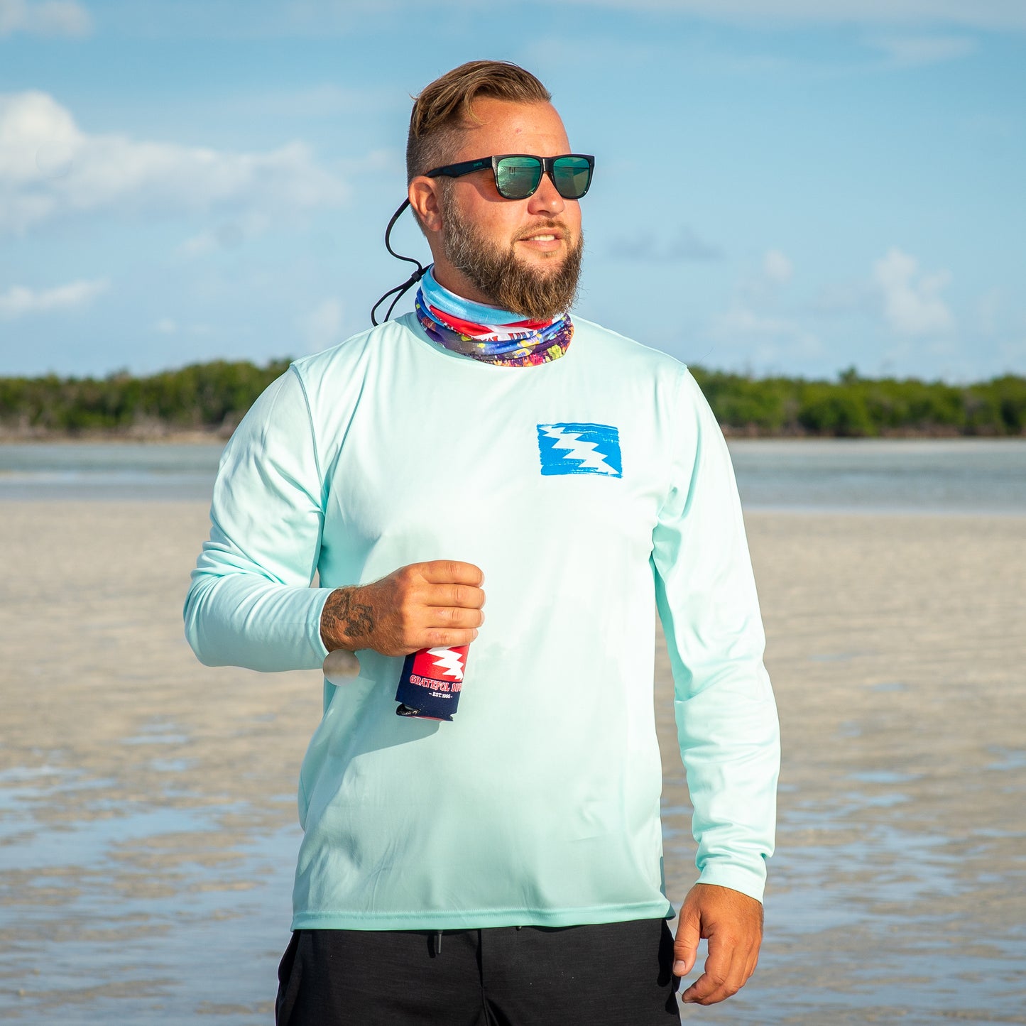 Grateful Diver Artist's Collection by Irina Pushkareva: Caribbean Reef Octopus UV Shirt in arctic blue front shot on model on sandbar