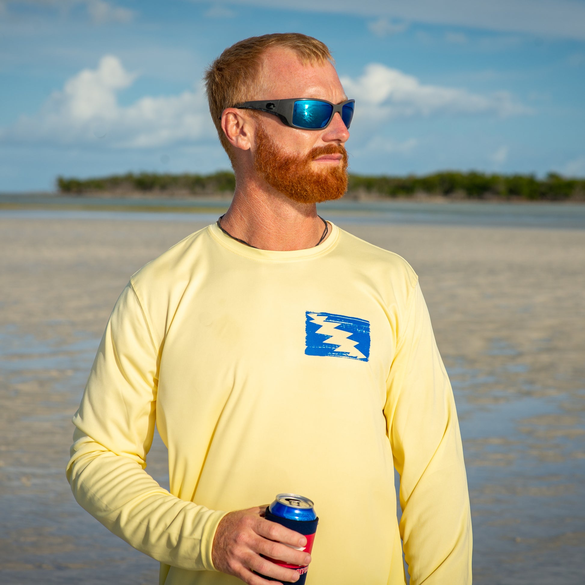 Grateful Diver Artist's Collection by Irina Pushkareva: Hawksbill Turtle UV Shirt in pale yellow front shot on model on sandbar