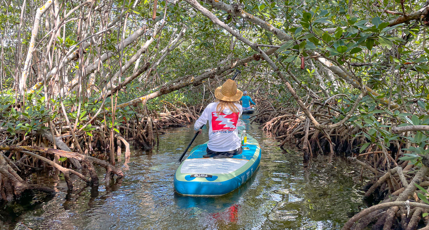 woman kayaking through mangroves in a Grateful Diver Classic UV Shirt Hoodie