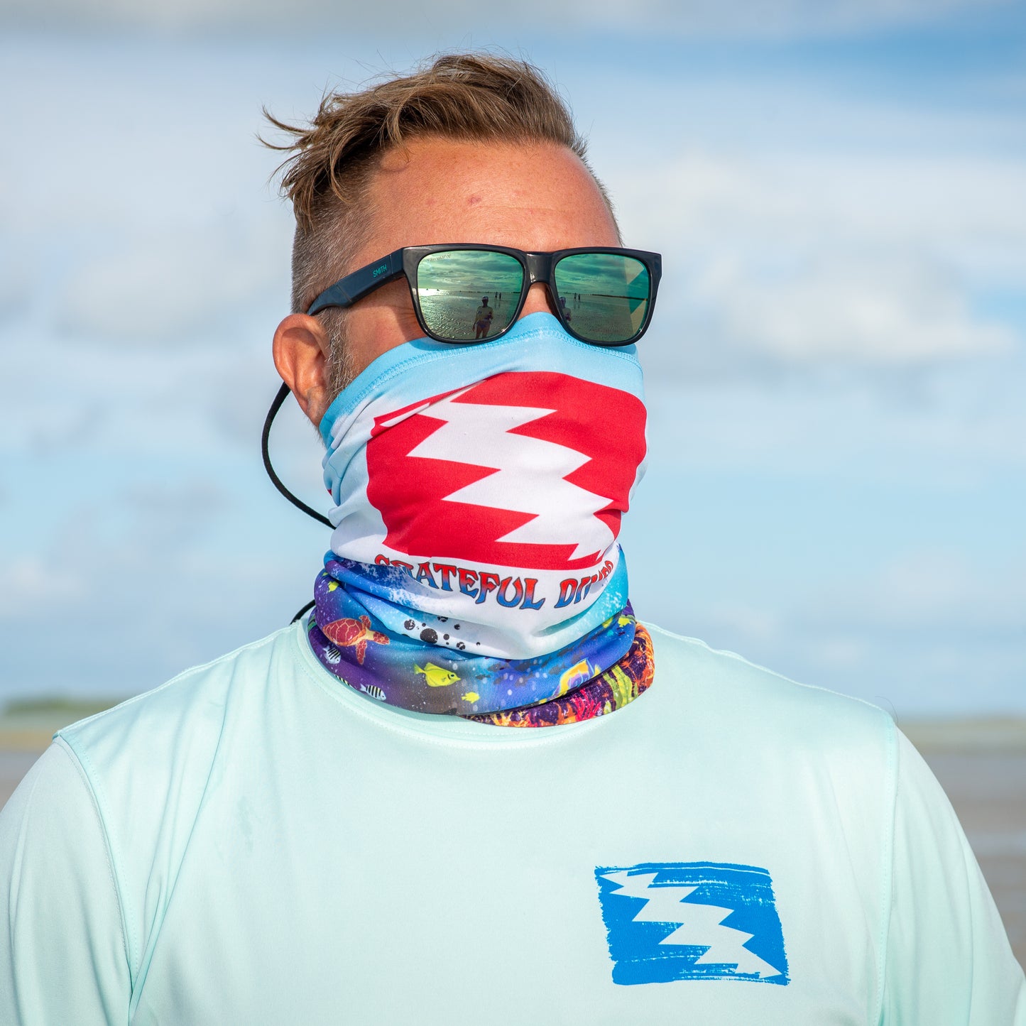 Grateful Diver Reef Diver Neck Gaiter worn as mask on model in front of ocean