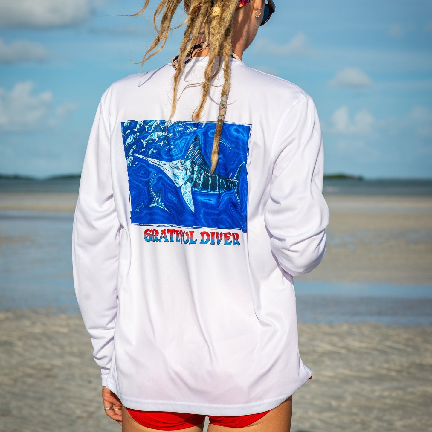 Grateful Diver Artist's Collection by Irina Pushkareva: Source of Light UV Shirt in white back shot on model on sandbar