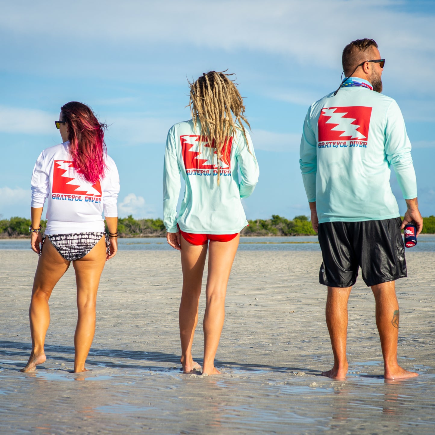Grateful Diver Classic UV Shirt in white and seagrass on three models back shots on sandbar